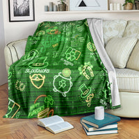 Green St. Patrick's Day blanket with neon clover, pot of gold, and brick pattern