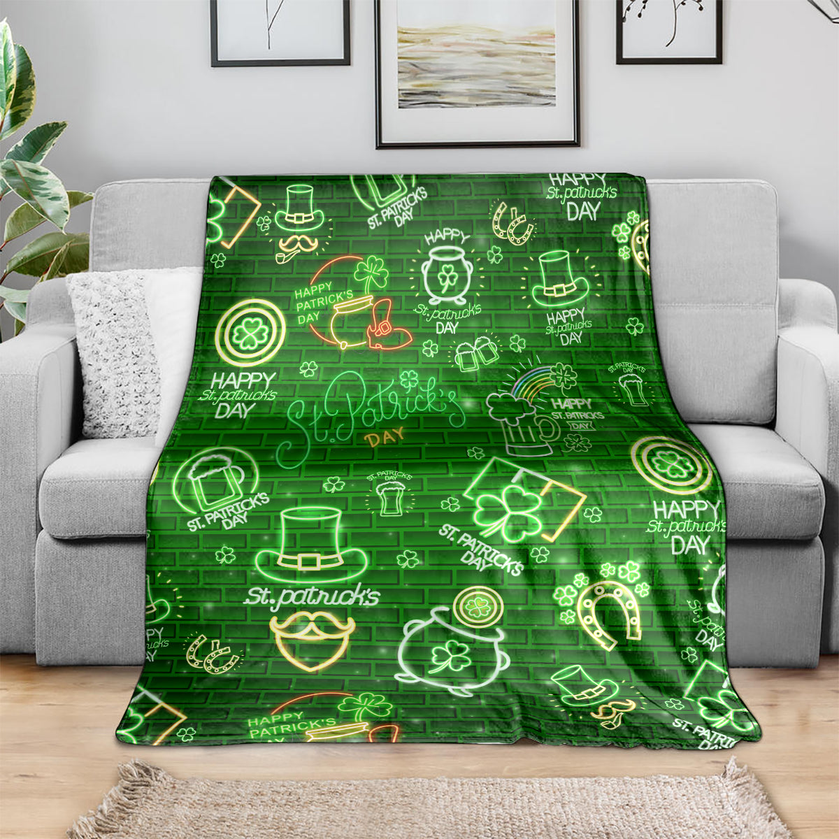 Green throw blanket spread on sofa with neon clover, horseshoe, and pot symbols