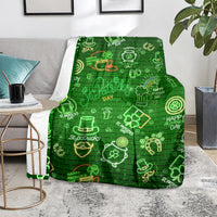 Green blanket on carpet with neon St. Patrick's Day icons in a brick-lined design