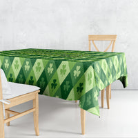 Green clover-pattern tablecloth draped over table with patterned edge