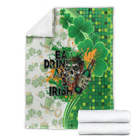 Folded green and white blanket with clovers and Eat Drink and Be Irish text