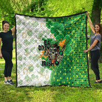 St. Patrick's Day quilt draped on grass: green and white clover design with slogan text