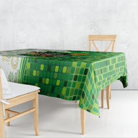 Green tablecloth with all-over mosaic pattern, draped over dining table
