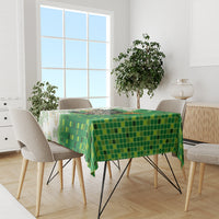 Green and white dining tablecloth with mosaic pattern covering the tabletop