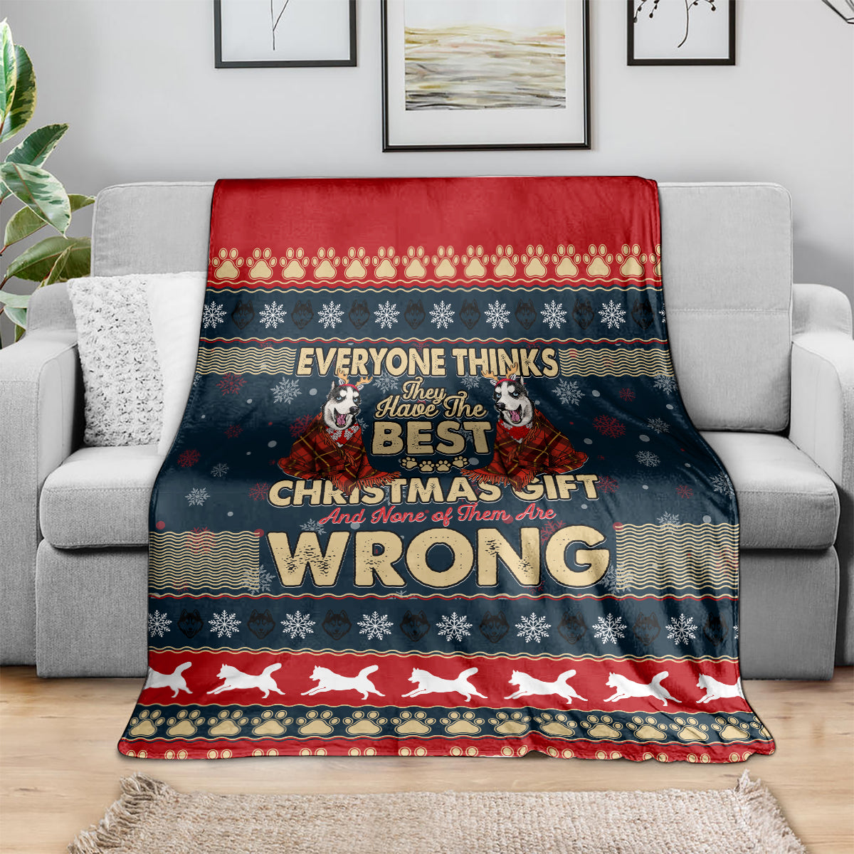 Christmas blanket draped on sofa, dark blue with red border and husky 'WRONG' print