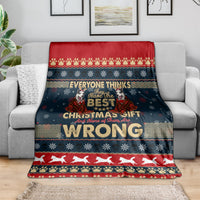 Christmas blanket draped on sofa, dark blue with red border and husky 'WRONG' print