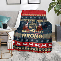 Christmas blanket on chair, dark blue with red border, husky graphic and 'WRONG' wording
