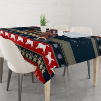 Navy and red Christmas tablecloth on dining table with white dog motif and patterned edge