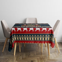 Square red and navy Christmas tablecloth with white dog silhouettes across the tabletop
