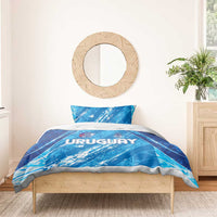 Sky blue duvet with URUGUAY lettering and crest, shown on a bed with one pillow