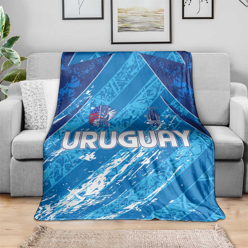 Blue Uruguay 2024 football blanket draped over a sofa with bold URUGUAY logo