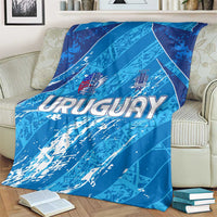 Blue Uruguay 2024 football blanket on a couch, close-up URUGUAY lettering