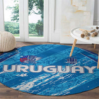 Sky blue round Uruguay rug with centered 'URUGUAY' wordmark and crest icons
