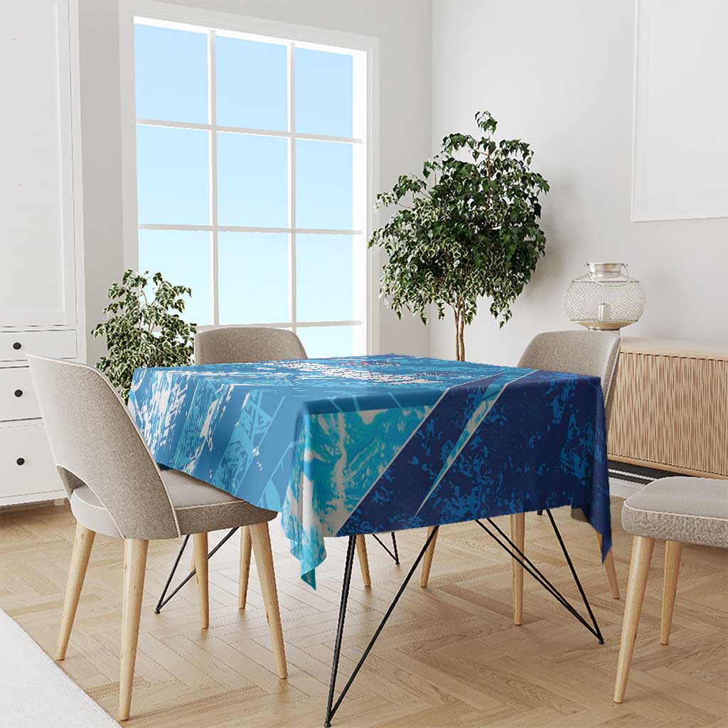 Sky blue Uruguay-themed tablecloth spread on dining table with chairs around