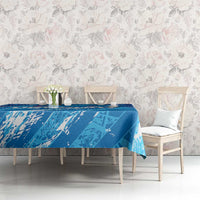 Sky blue football tablecloth on dining table with chairs and vase near center