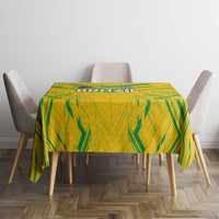 Yellow tablecloth with green abstract pattern, neatly laid on a dining table
