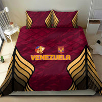 Maroon Venezuela football bedding set laid flat with two pillows and gold-and-black wings