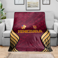 Wine-red Venezuela football blanket with crest logos and black-and-gold wave trim