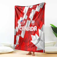 Red and white Canada-themed blanket with “CANADA” text and emblems