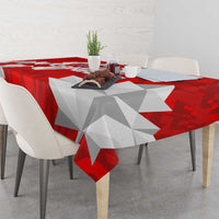 Red and white geometric tablecloth draped on dining table with Canada theme
