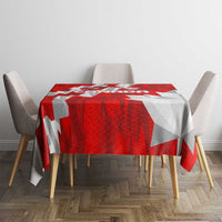 Red and white Canada-themed tablecloth on a dining table, bold geometric pattern
