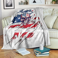 American flag skull blanket laid across couch, white fabric with blue stars and red striping