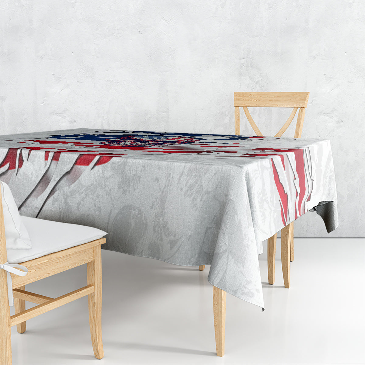 White tablecloth draped over a table, featuring red and blue American flag skull print