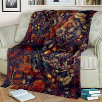 Skull art blanket with red, blue, and orange skulls and flowers on a couch