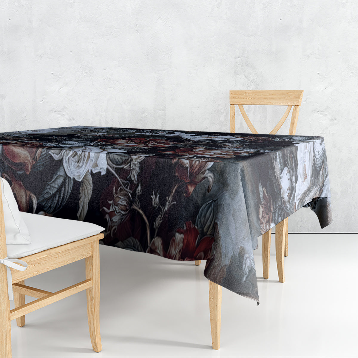 Dark tablecloth with rose and serpent print, hanging over table edge