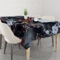 Dark floral serpent tablecloth covering dining table with overhanging corners