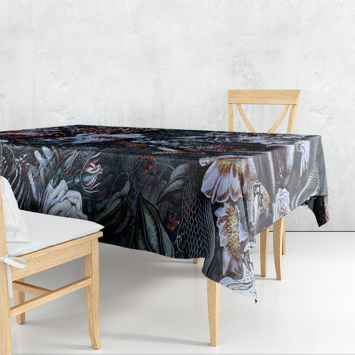 Black tablecloth with dark floral and skull print, hanging over table