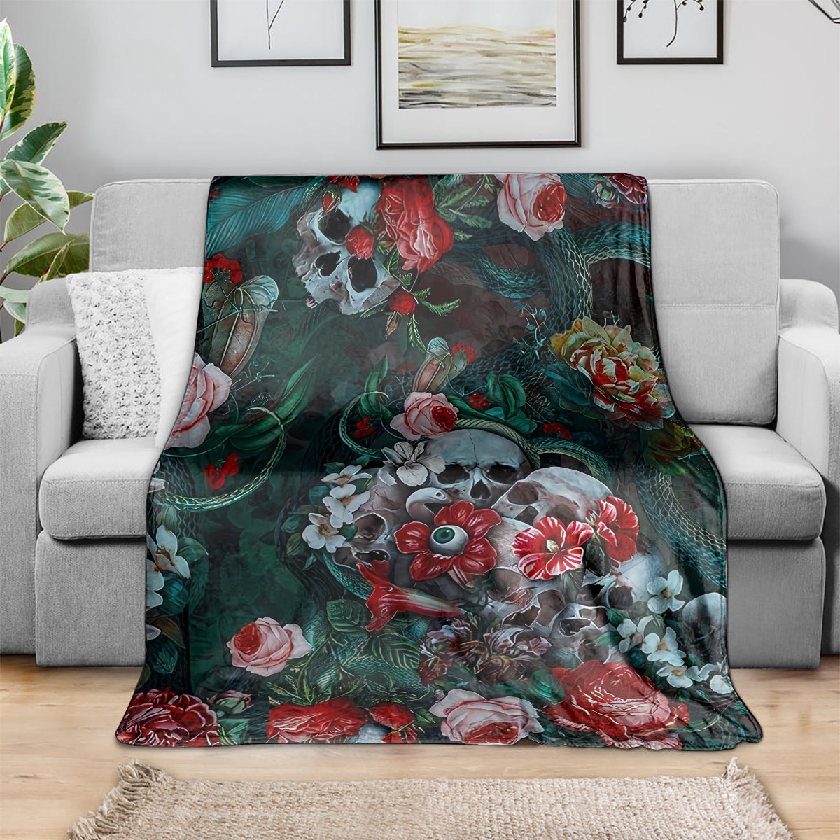 Teal and dark green floral skull blanket DT02 draped over couch with red roses