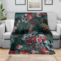 Teal and dark green floral skull blanket DT02 draped over couch with red roses