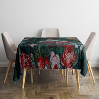 Green floral tablecloth on dining table with four chairs, dark rose and leaf print