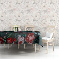 Green floral tablecloth on table with rose pattern, layered over dark base fabric