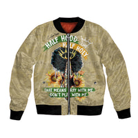 Beige bomber jacket, black ribbed cuffs, front zipper, half-hood graphic on front