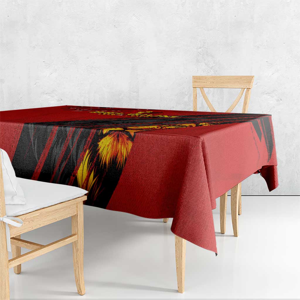 Red tablecloth with black striped panel and golden lion head graphic