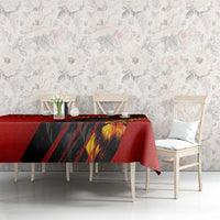 Red tablecloth with black diagonal stripes and yellow lion face print