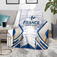 France football blanket, blue wing pattern with France Eur 2024 crest, on gray couch
