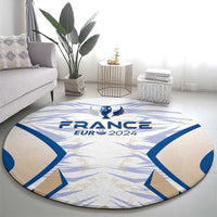 Round France EURO 2024 trophy rug with blue star-like pattern on light gray-beige