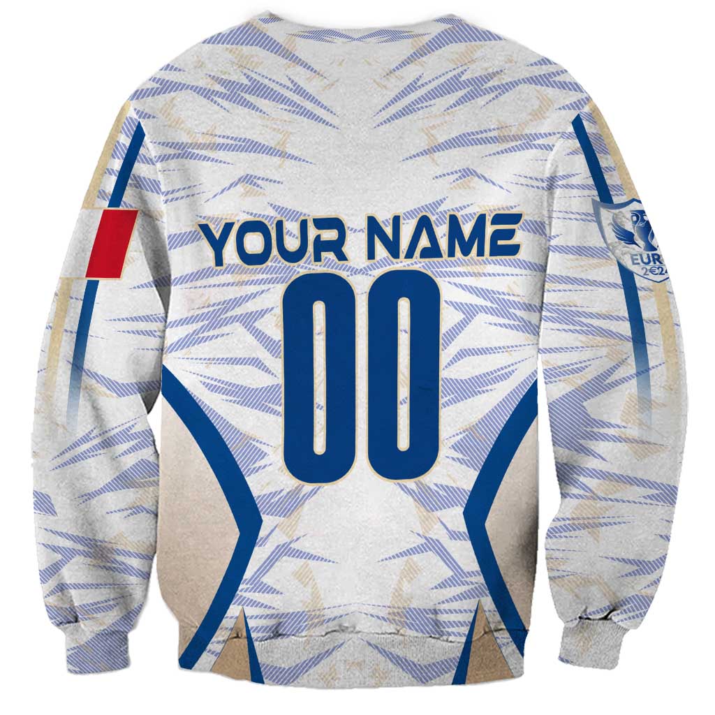 White sweatshirt back with blue name and number print, geometric pattern, long sleeves