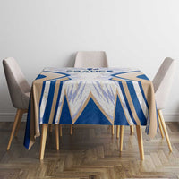 Small dining table covered with blue and white France-themed tablecloth design