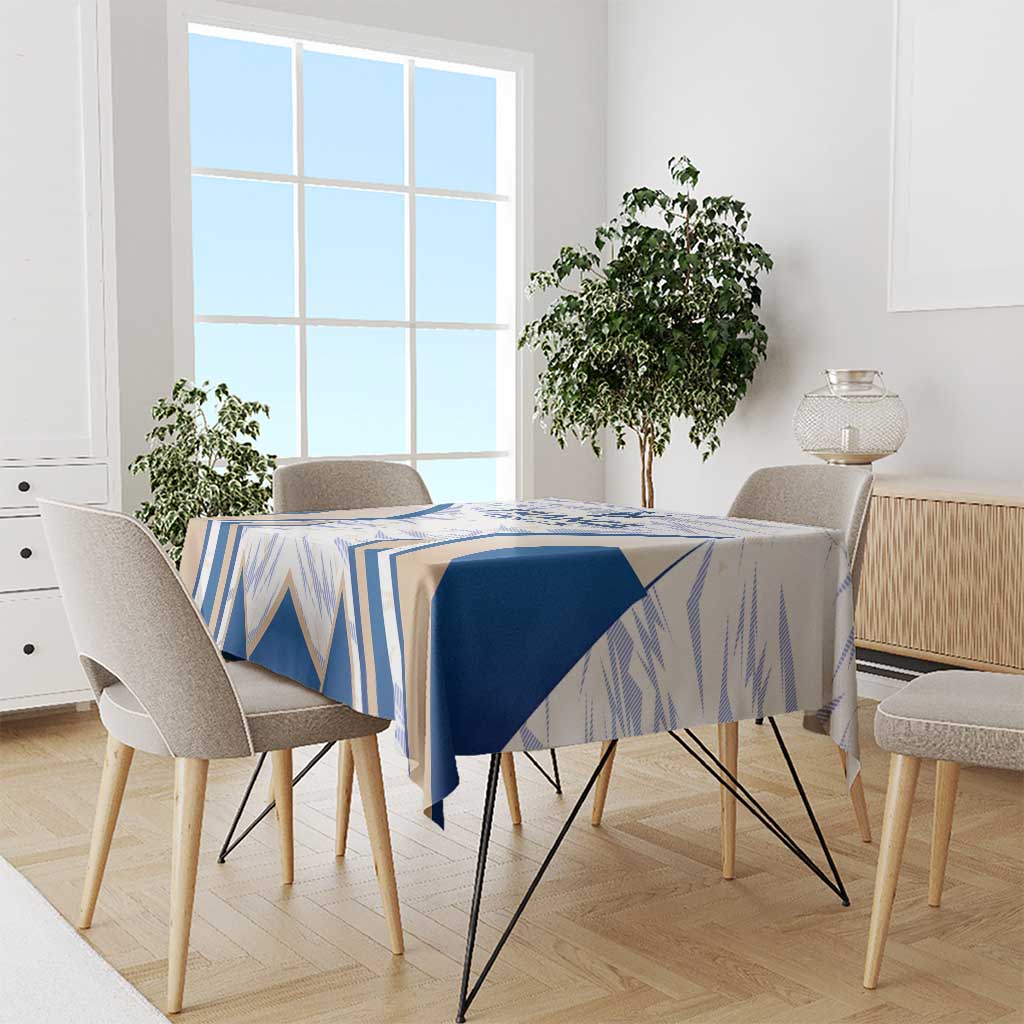 Blue-and-white France-themed tablecloth draped over dining table