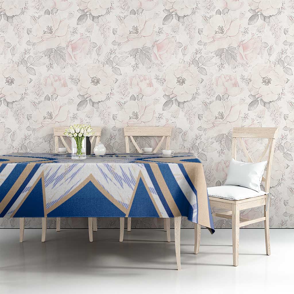 Rectangle dining table covered with blue and white geometric France-themed tablecloth