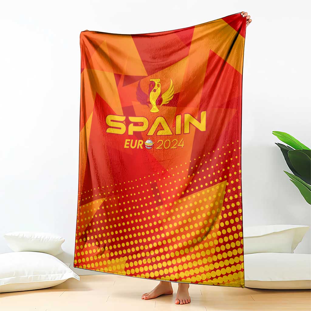 Spain football blanket draped over sofa, red-orange pattern with SPAIN EURO 2024 text