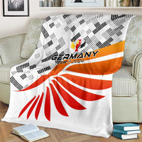 Germany football blanket on couch, white fabric with black diamond print and red rays