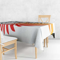 White tablecloth with red-orange striped wing graphic and smooth drape on table