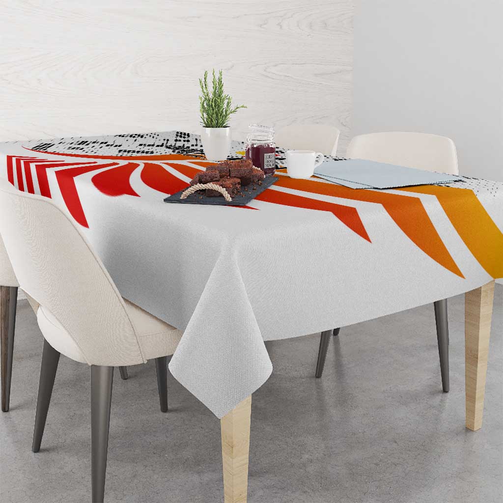 White tablecloth with red-orange stripe pattern across tabletop and hanging edges