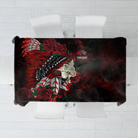 Black tablecloth with red feathered skull and roses graphic, draped over tabletop