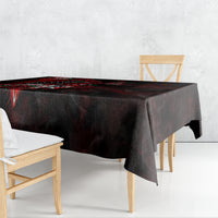 Black tablecloth draped over rectangular table, red skull and rose motif along edge